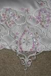 Lace appliquie with hand beeding and sequenes surrounding skirt and train.